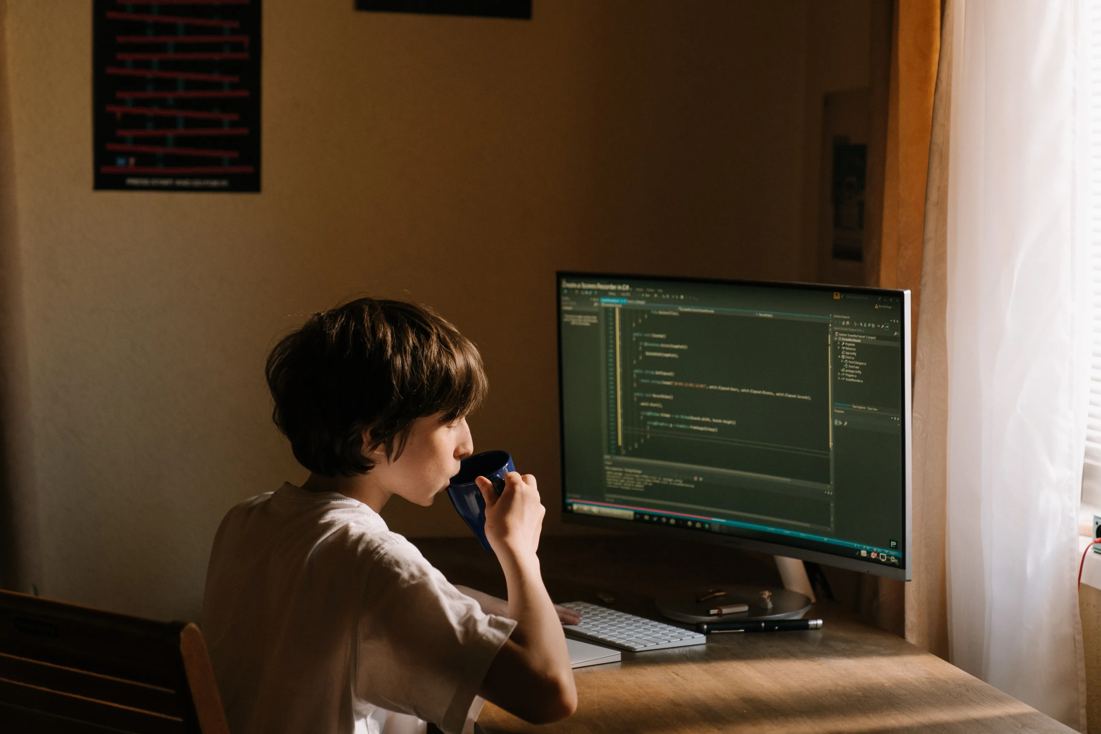 Boy in White T-shirt Sitting on Chair in Front of Computer Boy in White T-shirt Sitting on Chair in Front of Computer